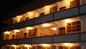 A multi-story building with multiple windows and balconies. - Eco Hotel El Refugio, In the mountains but near the sea. - ROOM 8 (PLUMA HIDALGO)