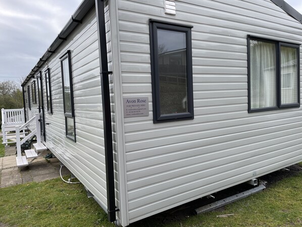 A mobile home with a sign advertising private hire services. - Avon Rose Stunning Dog-Friendly Caravan on Rockley Park, Poole Harbour, Dorset (Poole)