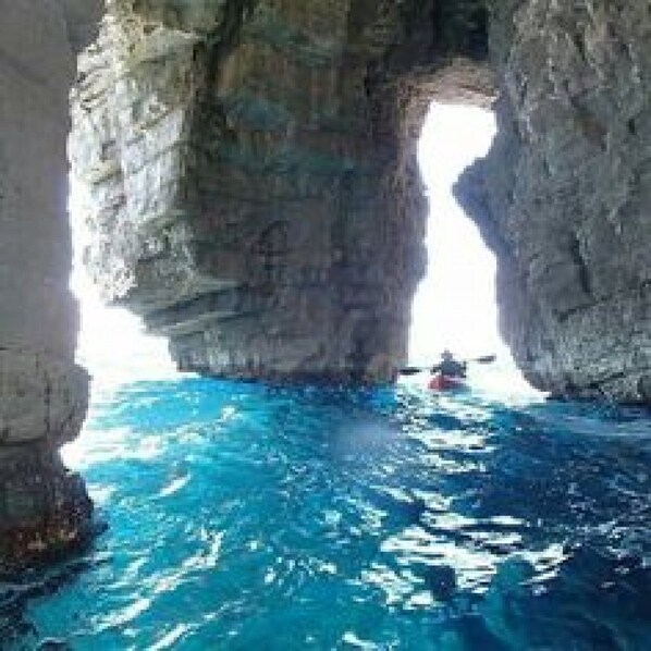 A natural rock formation with a clear water passage.