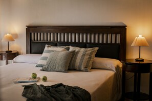 A neatly made bed with pillows, a bedside lamp, and a book on the bed. - CAN NOVES-Fabulous villa in a central and quiet area (Sant Francesc de Formentera)