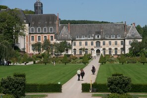 A large, historic building with a symmetrical facade, multiple windows, and a central entrance.