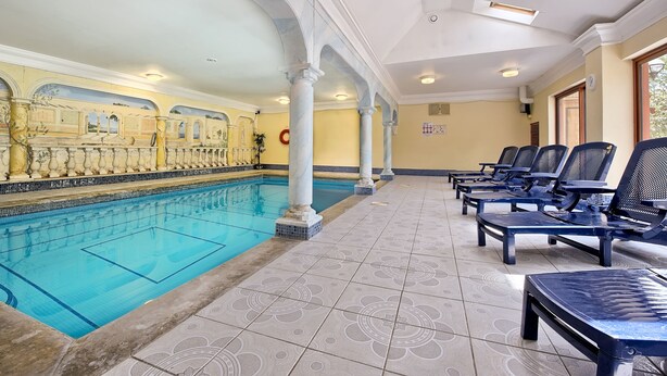 A swimming pool with lounge chairs, a tiled floor, and a ceiling with skylights. - Large sunny fresh two bedroom apt in London ideal for tourists, refurbished  (London)