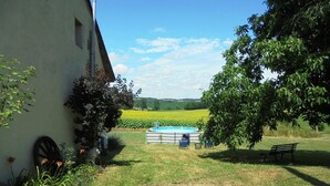 A rural setting with a swimming pool, a bench, and a path leading to a building. - Characterful and Spacious 2 Bedroom Gite, Sleeps 4 with Dedicated Pool (Pillac)