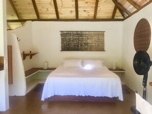 Cozy retreat with a single bed, wall-mounted artwork, and a simple design.