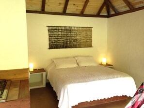 Relax in this serene bedroom with a comfortable bed, bedside tables, and soft lighting.