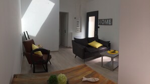 A modern living room with a sofa, a chair, a coffee table, and a dining table. - House "Pont Transbordeur" Rochefort city center (Rochefort)