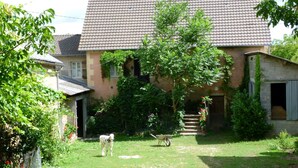 A house with a tiled roof, a front yard, and a small tree. - Farm cottage in activity  (Vaureilles)