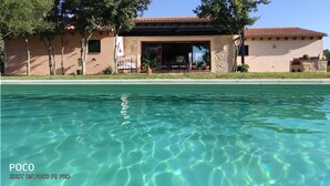 A building with a pool in front.