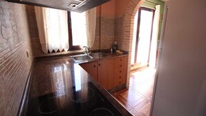 A kitchen with a granite countertop, a built-in stove, and a sink.