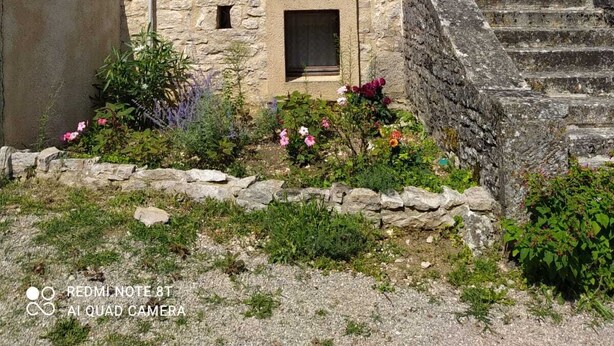 A stone building with a tower, a small window with shutters, and a staircase leading to a door. - Le Petit Paradis - Cottage for 8 people with Private Pool in the Countryside (Caylus)