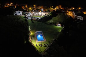 A large, well-lit residential property with a swimming pool, multiple houses, and a well-maintained lawn. - The House of Pedros (Villar)