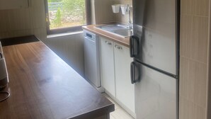 A modern kitchen with a dishwasher, refrigerator, and microwave. - Peaceful holidays for an active family (Stari Grad)