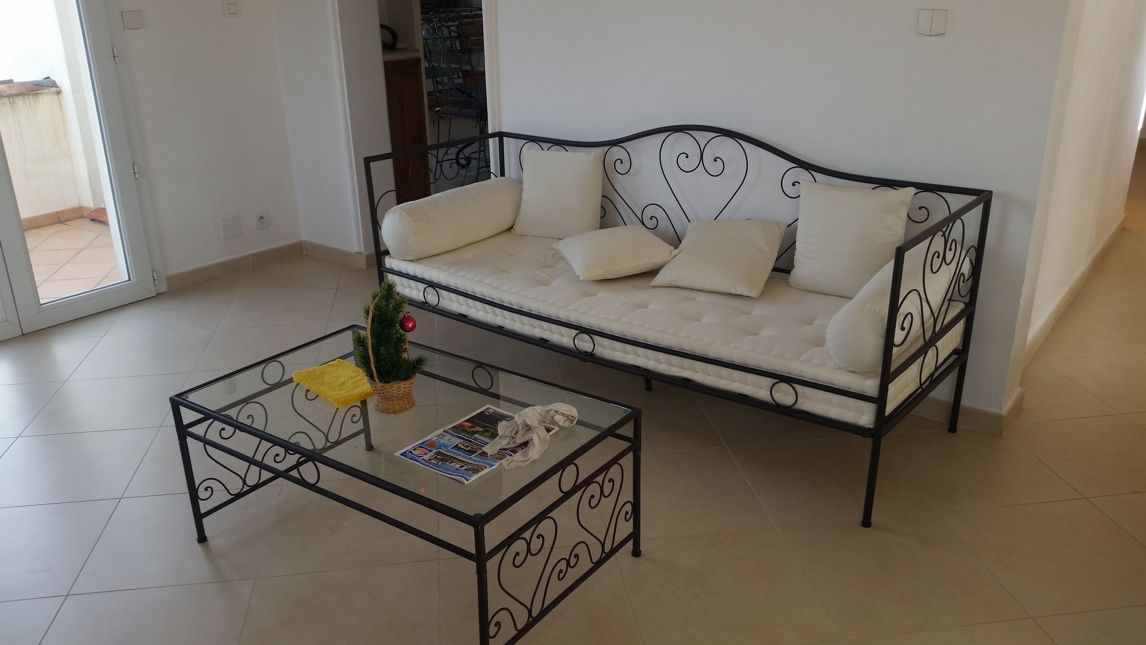 A modern living room with a sofa and a glass coffee table.