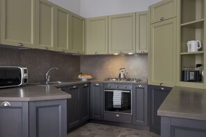 A kitchen with a microwave, sink, stove, and oven.