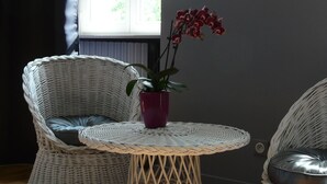 A room with wicker chairs and a small round table with a potted plant. - TOWNHOUSE - LYON COUNTRYSIDE - LARGE GARDEN (Grenay)