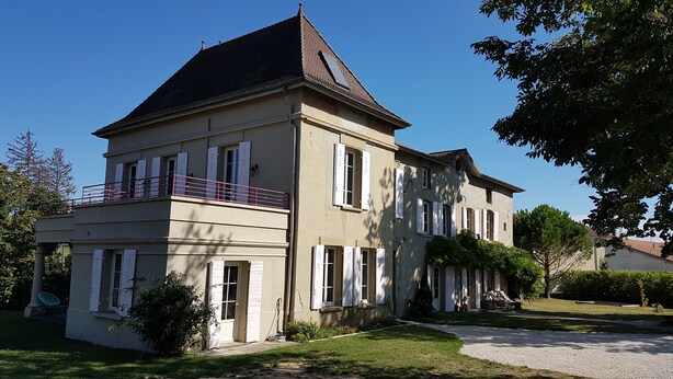 A two-story building with a balcony, large windows, and a well-maintained lawn. - TOWNHOUSE - LYON COUNTRYSIDE - LARGE GARDEN (Grenay)