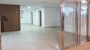 A spacious hallway with a glass door leading to an outdoor area.