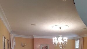 A living room with a fireplace, two white armchairs, a yellow sofa, and a chandelier. - VILLA HEMI, WITH DOUBLE ROOMS (Lomitos de Correa)