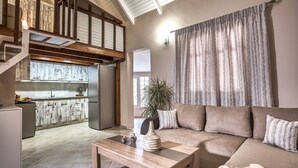 A spacious living area with a high ceiling, a modern kitchen, and a large window with curtains. - CORAL  VILLA with private pool at 100 m from the sea (Zante (Zacinto))
