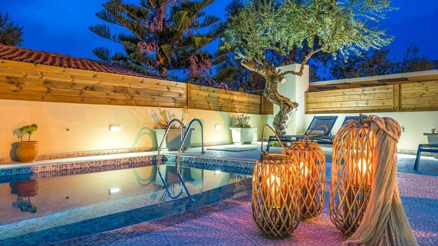 A swimming pool with a wooden deck, a tree, and lounge chairs. - CORAL  VILLA with private pool at 100 m from the sea (Zante (Zacinto))