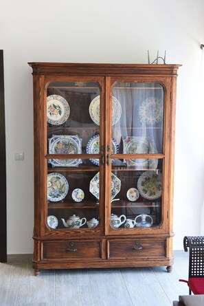 Traditional cabinet showcases an array of dishes and teapots.