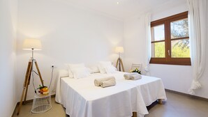 A hotel room with two beds, white linens, a window with curtains, and two floor lamps. - Finca Ses Quaranta (Campos)