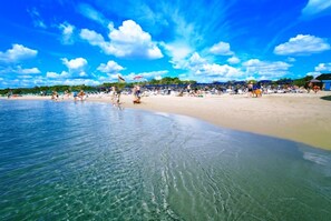 A beach with clear water, sandy shore, and people sunbathing. - VILLA IL CARRUBO-unit2 € 500 per week with 3 bedrooms for 10 persons (Pisticci)