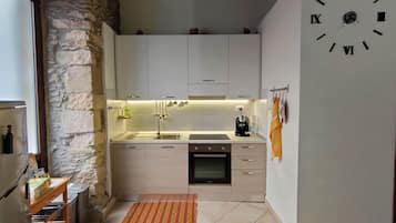 Een koelkast, een oven, een kookplaat, een koffiezetapparaat/waterkoker