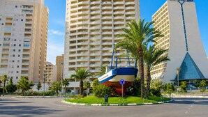 A high-rise hotel with a distinctive modern design, featuring a large glass facade and a unique triangular structure. - New apartment with stunning views (Calpe)