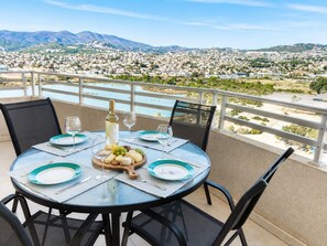 A round table with a view of a cityscape and mountains in the background. - New apartment with stunning views (Calpe)