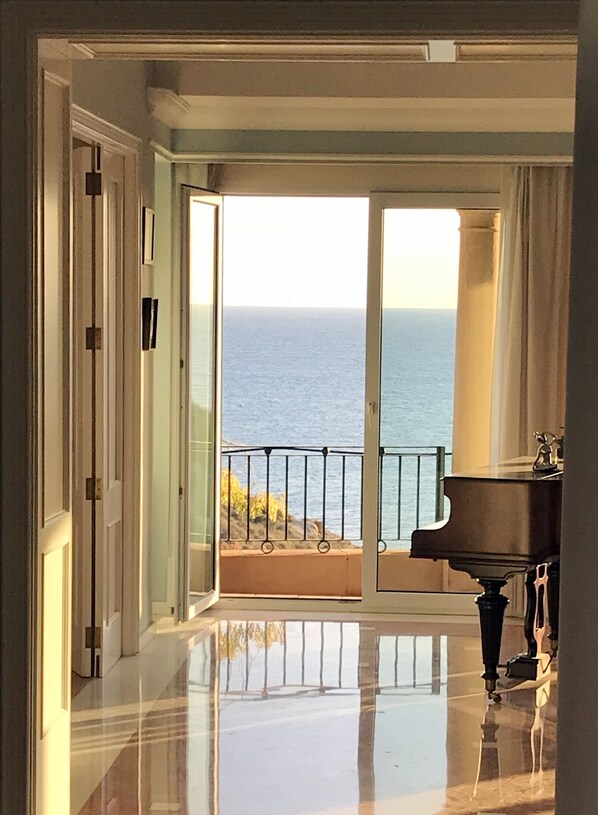 Enjoy ocean views from the balcony, where a grand piano adds a touch of elegance.