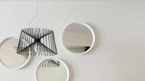 Un comedor moderno con una mesa redonda y cuatro sillas de patas de madera.