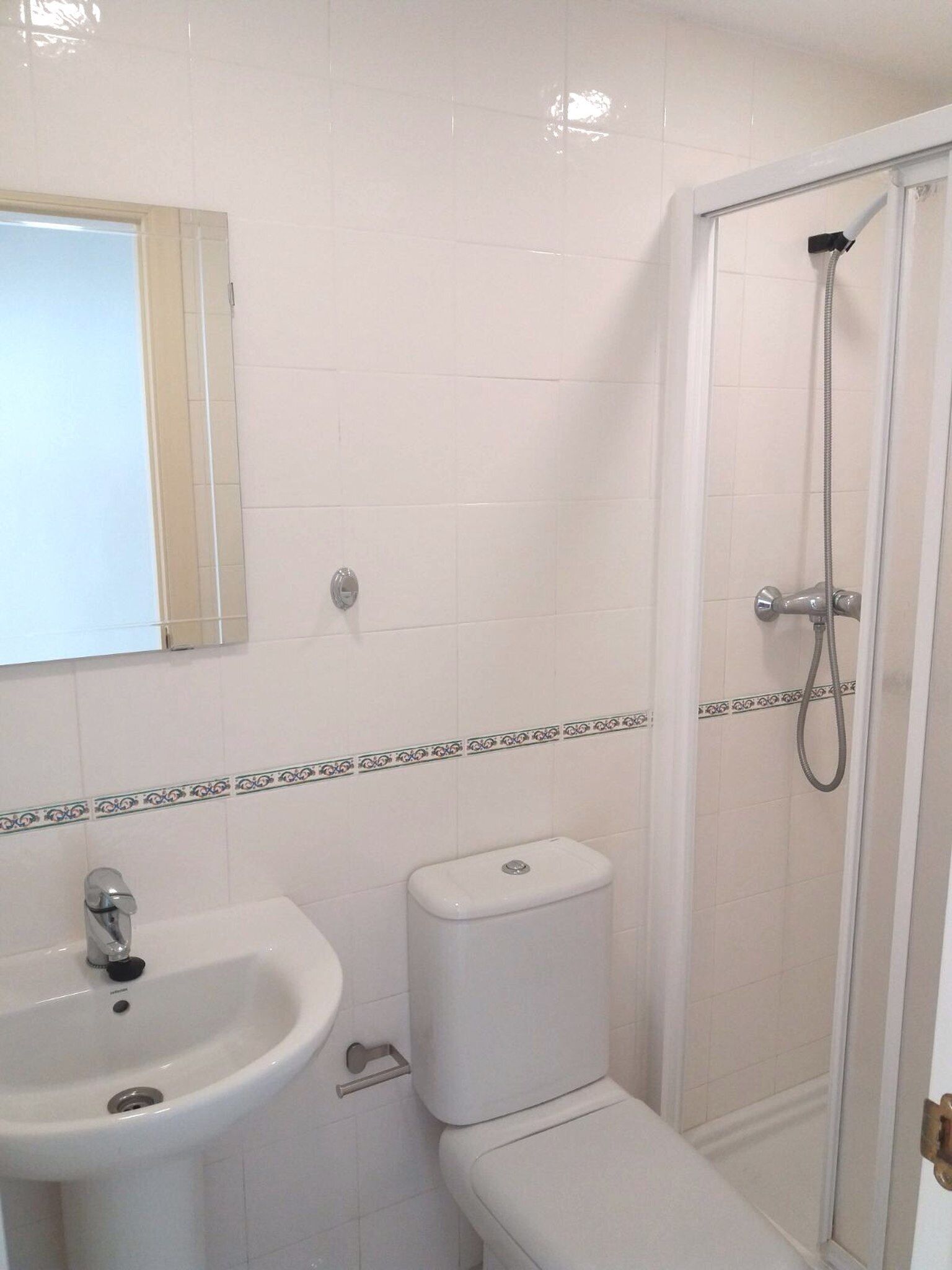 A bathroom with a sink, toilet, and shower.