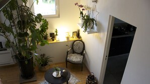 A compact living space with a zebra-striped chair, a small round table, and various potted plants. - Large & beautiful villa on large landscaped fenced garden, large secure pool. (Montpellier)