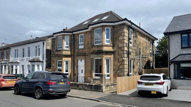 A row of terraced houses with a street in front. - Elderpark Apartment 4 (Glasgow)