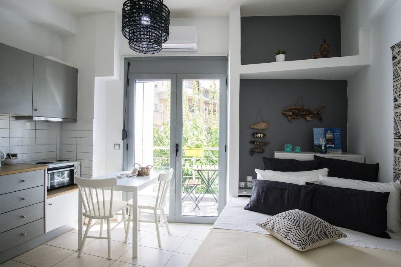 A modern apartment with a kitchen, dining area, and a balcony.