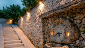 A stone staircase leading up to a building with a rustic stone wall and a wooden beam above. - Siora Tanto Villa, a combination of rustic charm and modern flair!  (Lefkada)