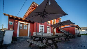 A building with outdoor seating and a staircase leading to the entrance. - Apartamentos Jesús for 4 people (Valdés)