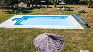 A rectangular swimming pool with a blue interior, surrounded by a white deck. - Apartamentos Jesús for 4 people (Valdés)