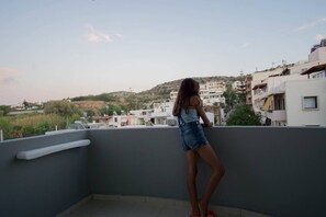 A balcony with a view of a residential area, including buildings and a hill. - Urban Beach Sea (3C) (Rethymno)