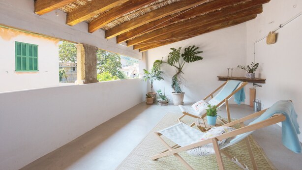 A room with a wooden ceiling, a window with green shutters, a hammock, and several potted plants. - Mlle. BIBI Casa Tipica Soller in center of Soller. Parking at 500m included.  (Sóller)