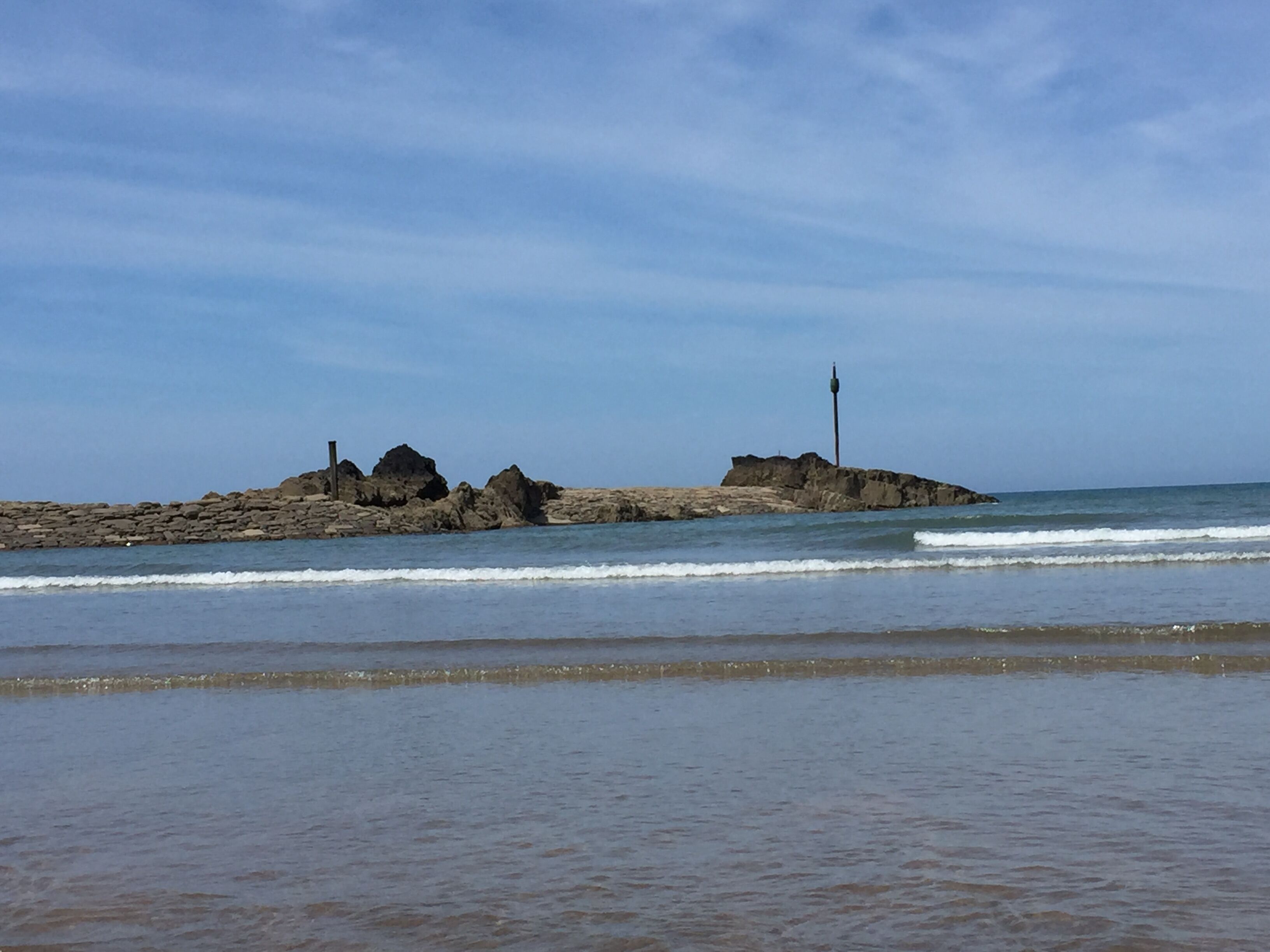 A rocky shoreline with waves approaching.