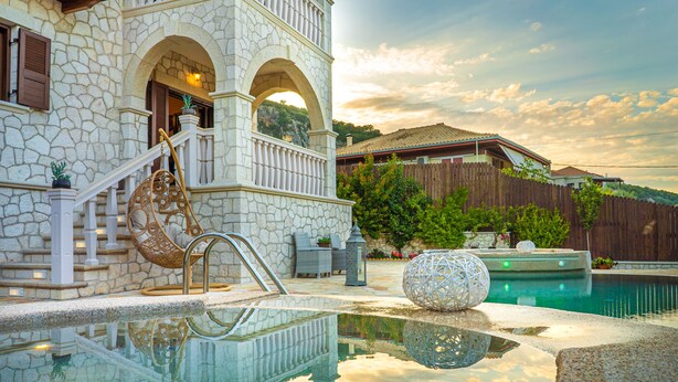 A stone building with a pool, a wooden fence, and a wooden deck. - Fairytale Villa, in the heart of Lefkas town and Agios Ioannis beach! (Lefkada)