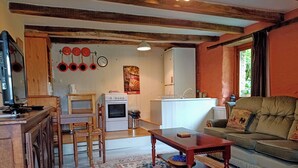 A compact living space with a kitchen, dining area, and seating area. - LA GRANGE A CONVERTED BARN IN THE BEAUTIFUL HAMLET OF TALROCH (Melrand)