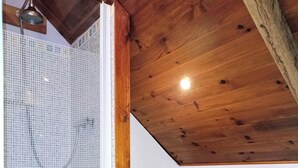 A bathroom with a shower, toilet, and a wooden bench. - LA GRANGE A CONVERTED BARN IN THE BEAUTIFUL HAMLET OF TALROCH (Melrand)