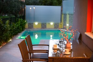A glass-top table with wicker chairs, a vase with flowers, and a teapot and cup set. -  TROGIR PRIVATE POOL SUNBATHING TERRACE just steps from old town!!!  (Trogir)