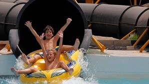 A person in a yellow inflatable tube at the entrance of a water slide. - Ground Floor Apartment in Palomares with Communal Pool (Palomares Almeria)