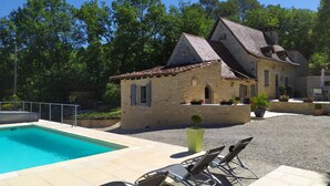 A stone building with a tiled roof, a swimming pool, and outdoor seating. - House / Villa - PONTCIRQ (Pontcirq)