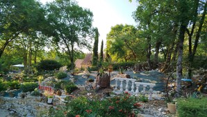 A garden with a stone wall, red flowers, and a 'DANGER' sign. - House / Villa - PONTCIRQ (Pontcirq)
