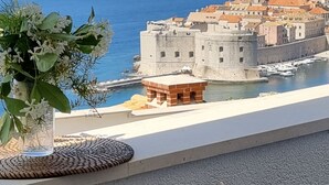 A coastal cityscape with historic buildings and a fortified structure by the sea. - Apartment Marijana The most amazing breathtaking view to the sea and Old Town! (Dubrovnik)